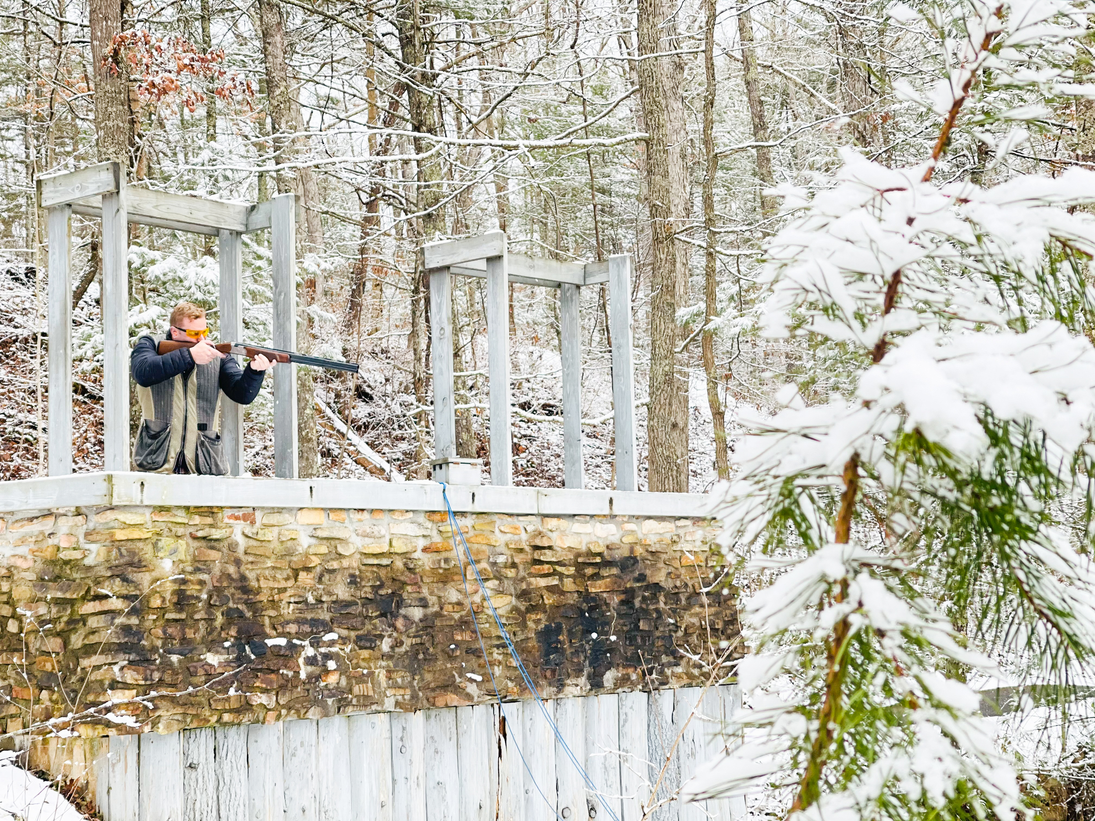 man-aiming-gun-in-winter