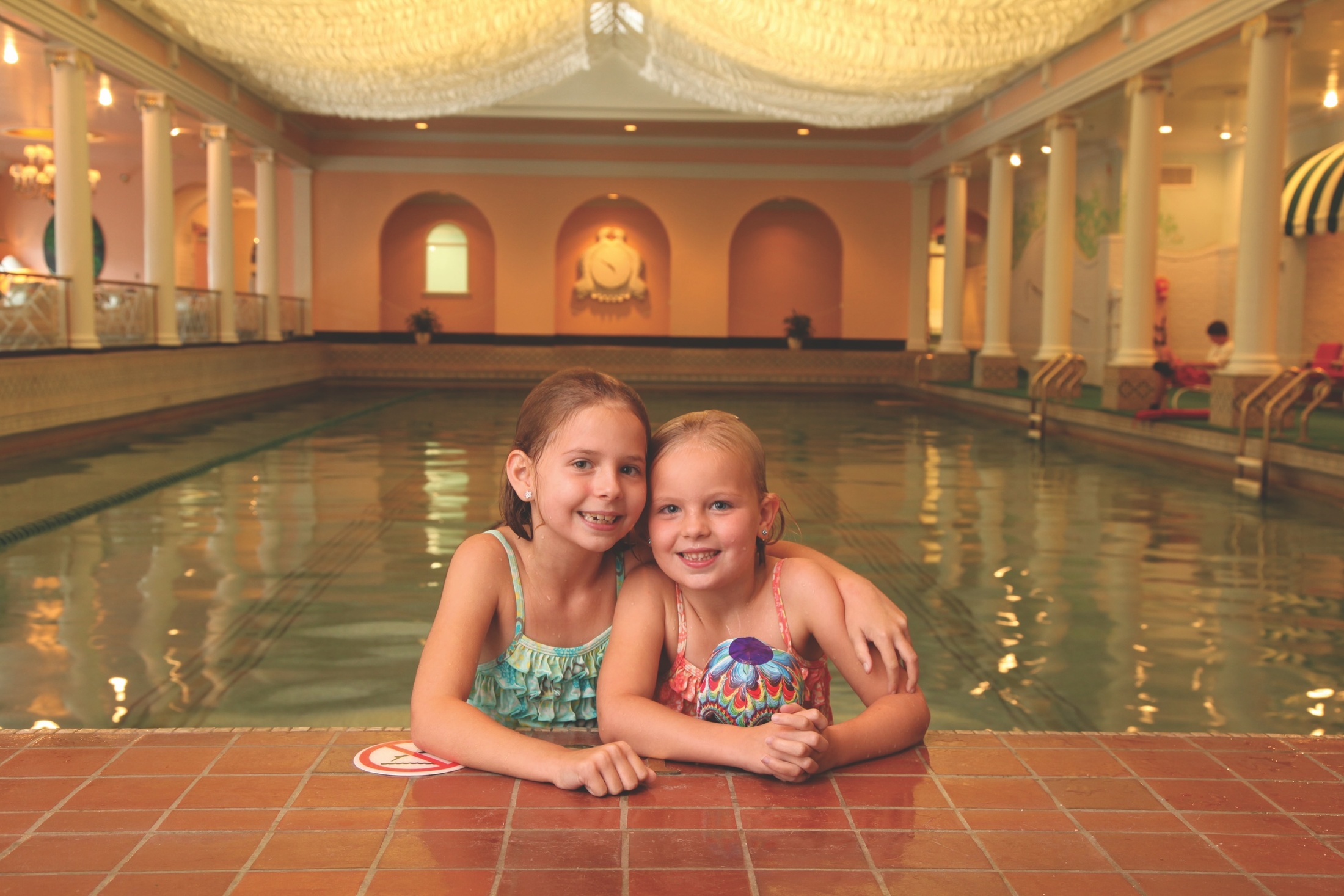 children-hugging-in-indoor-swimming-pool