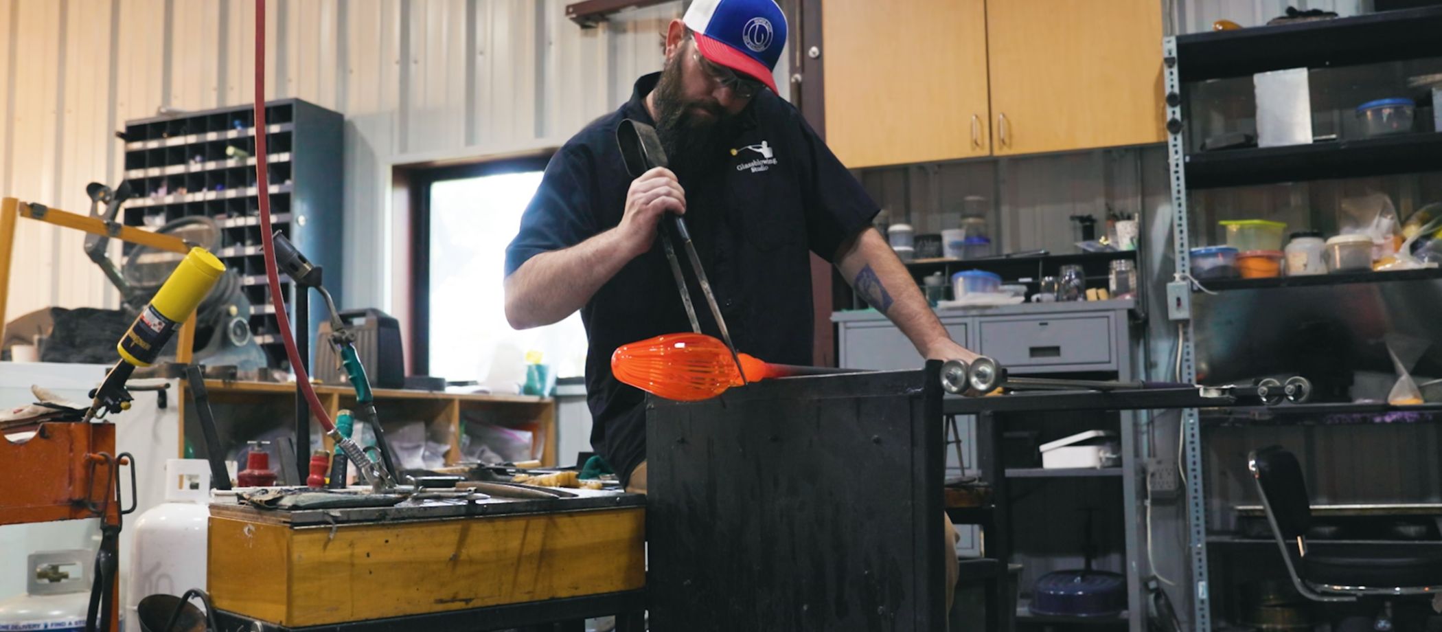 man-blowing-glass