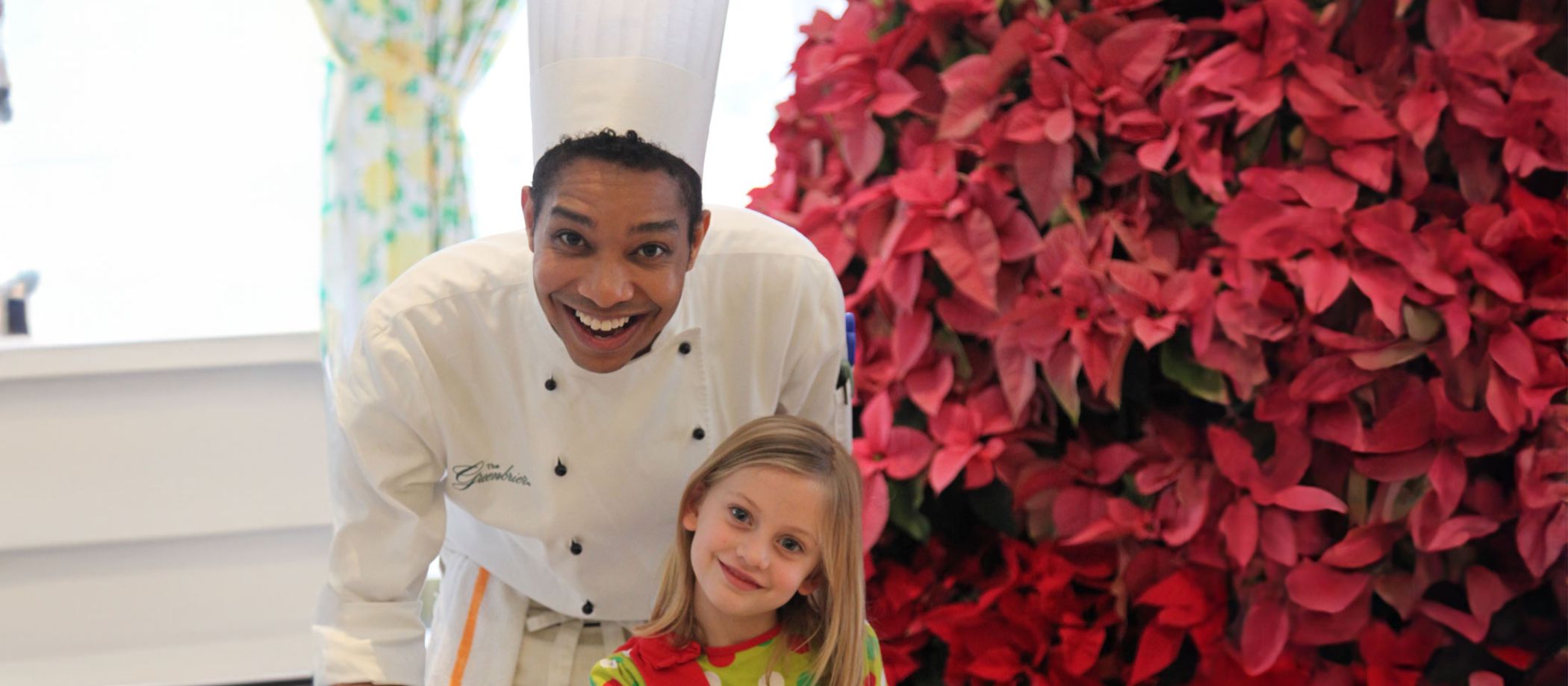 A chef and a child smiling