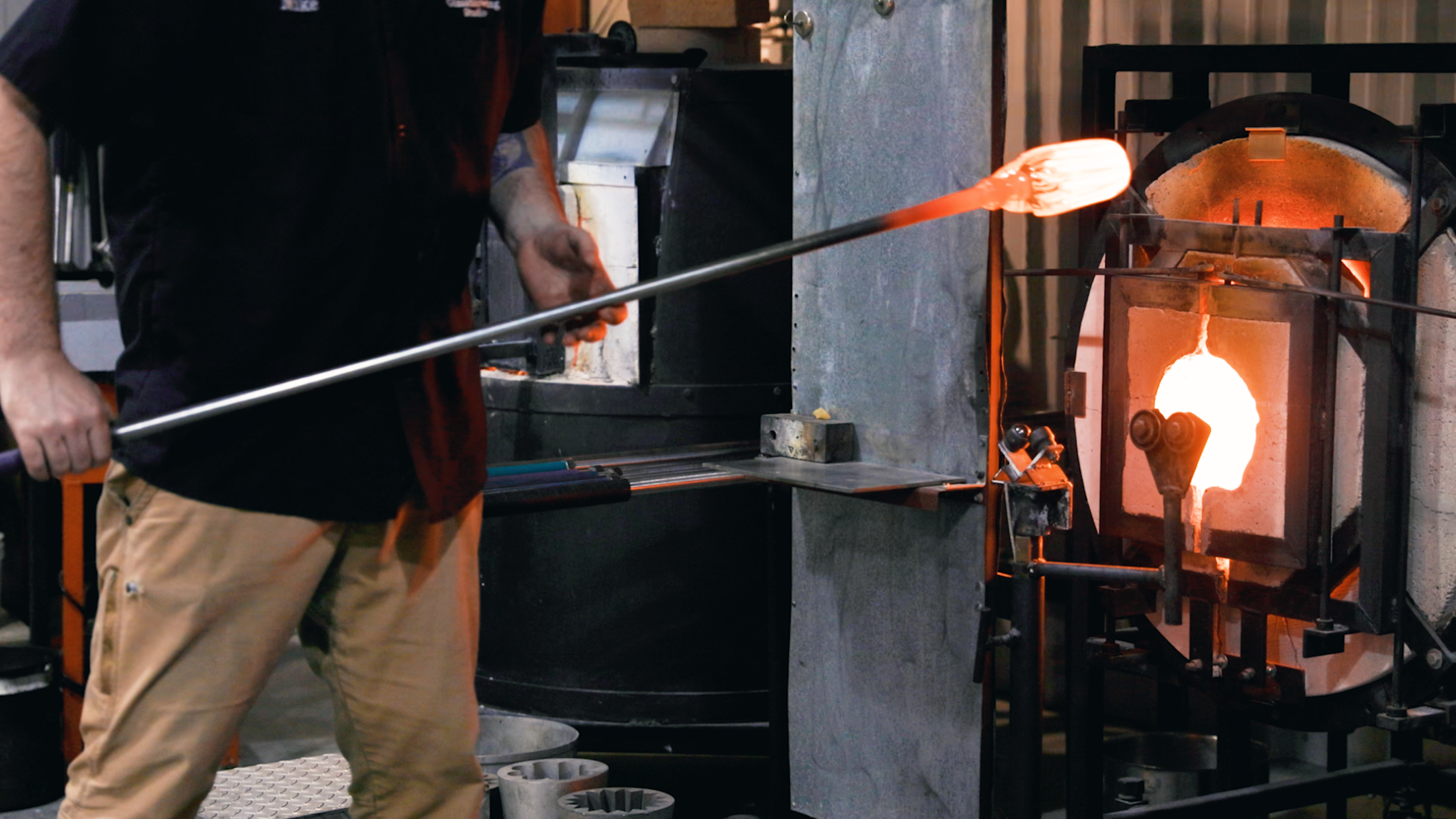 person-putting-glass-blowing-in-fire