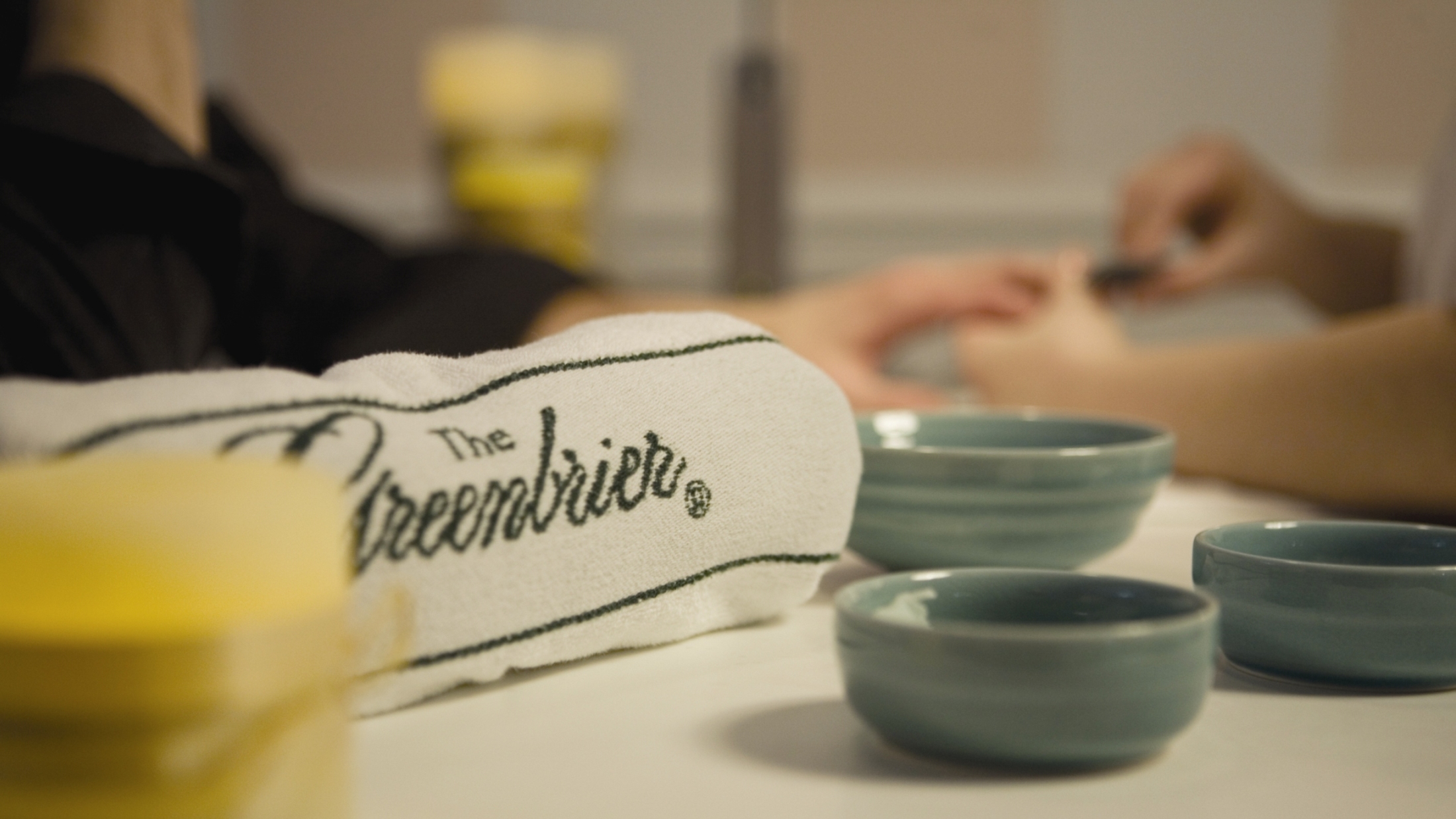 person-getting-manicure-towel-bowls